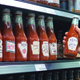 Bottles of novelty Heinz ketchup on grocery store shelf